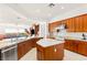 Open kitchen with stainless appliances, an island, granite countertops, and seamless flow into the living area at 20 Kittansett Loop, Henderson, NV 89052
