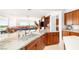 Bright kitchen featuring marble countertops, custom cabinetry, and a large island with stainless steel appliances at 20 Kittansett Loop, Henderson, NV 89052