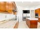 Well-lit kitchen with stainless steel appliances, modern cooktop, and granite countertops with seamless white backsplash at 20 Kittansett Loop, Henderson, NV 89052