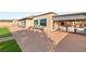 A large patio offers a covered outdoor kitchen, spacious seating, and beautiful landscape views at 20 Kittansett Loop, Henderson, NV 89052