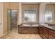 Bathroom featuring a large soaking tub, separate shower, and dual sink vanity at 205 Red Rock Rd, Boulder City, NV 89005