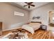 Bright bedroom featuring hardwood floors, natural light, and decorative motorcycle wall art at 205 Red Rock Rd, Boulder City, NV 89005