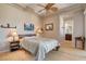 Cozy bedroom with ceiling fan, warm lighting, and an adjacent bathroom at 205 Red Rock Rd, Boulder City, NV 89005