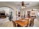 A large wooden dining table with chairs sits in an open dining room at 205 Red Rock Rd, Boulder City, NV 89005