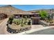 Stunning single-story home nestled in the hills with desert landscaping and an attached garage at 205 Red Rock Rd, Boulder City, NV 89005