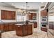 Well-lit kitchen with wood cabinets, granite counters, an island, and stainless steel double ovens at 205 Red Rock Rd, Boulder City, NV 89005