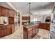 Spacious kitchen featuring wood cabinets, an island with cooktop, and stainless steel appliances at 205 Red Rock Rd, Boulder City, NV 89005