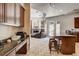 Open-concept kitchen with wood cabinetry, granite countertops, and seamless flow to living area at 205 Red Rock Rd, Boulder City, NV 89005