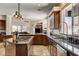 Well-equipped kitchen with granite counters, dark wood cabinets, and stainless steel appliances at 205 Red Rock Rd, Boulder City, NV 89005