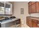 Spacious laundry room includes a washer, dryer, granite counters, cabinets, and natural light at 205 Red Rock Rd, Boulder City, NV 89005