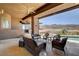 Covered patio offers comfortable seating, a ceiling fan, and scenic mountain views at 205 Red Rock Rd, Boulder City, NV 89005
