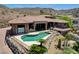 Stunning pool with attached spa surrounded by desert landscaping and mountain views, perfect for relaxing and entertaining at 205 Red Rock Rd, Boulder City, NV 89005