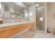 A spacious bathroom with double sinks, large mirror, and walk-in shower at 211 E Flamingo Rd # 1617, Las Vegas, NV 89169