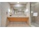 A bright bathroom with double sinks, a large mirror, and a walk-in shower at 211 E Flamingo Rd # 1617, Las Vegas, NV 89169