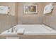 Relaxing soaker tub with tile surround and chrome fixtures at 211 E Flamingo Rd # 1617, Las Vegas, NV 89169