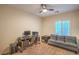 This bedroom offers lots of desk space, a ceiling fan, and natural light with window shutters at 2144 Marywood Park Ct, Henderson, NV 89044