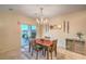 Elegant dining area with chandelier and sliding glass doors to the backyard at 2144 Marywood Park Ct, Henderson, NV 89044