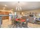 An open-concept floor plan features a dining table with seating and an elegant chandelier at 2144 Marywood Park Ct, Henderson, NV 89044
