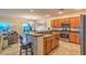 View of a kitchen with a breakfast bar with seating, stainless steel appliances, and wood cabinets at 2144 Marywood Park Ct, Henderson, NV 89044