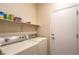 Convenient laundry room with a washer and dryer and shelving for storage at 2144 Marywood Park Ct, Henderson, NV 89044