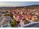 Expansive view of a well-maintained neighborhood with terra-cotta roofs backed by mountain vistas at dusk at 2144 Marywood Park Ct, Henderson, NV 89044