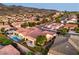 Aerial view showing community pool in a neighborhood with mature landscaping and terracotta tile roofs at 2144 Marywood Park Ct, Henderson, NV 89044