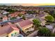 Aerial view showcasing a vibrant neighborhood with lush greenery and Spanish tile roofs at 2144 Marywood Park Ct, Henderson, NV 89044