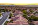 Overhead shot of a residential area boasting desert landscaping and terracotta roofs against a scenic horizon at 2144 Marywood Park Ct, Henderson, NV 89044