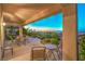Relaxing covered patio with seating area and landscaped backyard at 2144 Marywood Park Ct, Henderson, NV 89044