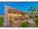 Covered patio showcases outdoor seating and a view of the interior dining area through sliding glass doors at 2144 Marywood Park Ct, Henderson, NV 89044