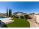 Beautiful backyard with pool, manicured lawn, and lush landscaping at 2200 Valley Heights Ave, Henderson, NV 89052