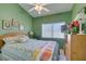 Green-walled bedroom with a ceiling fan and bright lighting showcases comfortable living at 2200 Valley Heights Ave, Henderson, NV 89052