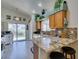 Bright kitchen features wood cabinets, granite countertops, and a breakfast bar with stainless steel appliances at 2200 Valley Heights Ave, Henderson, NV 89052
