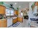 Bright kitchen with wooden cabinetry, granite countertops, stainless appliances, and a breakfast bar at 2200 Valley Heights Ave, Henderson, NV 89052