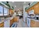 Bright kitchen with wooden cabinetry, granite countertops, stainless appliances, and a breakfast bar at 2200 Valley Heights Ave, Henderson, NV 89052