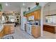 Bright kitchen with wooden cabinetry, granite countertops, stainless appliances, and a breakfast bar at 2200 Valley Heights Ave, Henderson, NV 89052