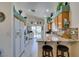 Bright kitchen features wood cabinets, granite countertops, and a breakfast bar with stainless steel appliances at 2200 Valley Heights Ave, Henderson, NV 89052