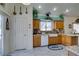 Traditional kitchen featuring wooden cabinets, white appliances, farmhouse sink and granite countertops at 2200 Valley Heights Ave, Henderson, NV 89052