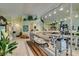 Bright living room featuring a quilting machine, mirrored wall and light parquet flooring at 2200 Valley Heights Ave, Henderson, NV 89052