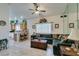 Bright living room featuring parquet flooring, ceiling fan and view to kitchen at 2200 Valley Heights Ave, Henderson, NV 89052
