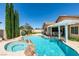 Stunning backyard pool and spa combination with covered patio and lush landscaping at 2200 Valley Heights Ave, Henderson, NV 89052