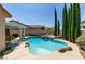 Inviting swimming pool surrounded by rock features and mature trees at 2200 Valley Heights Ave, Henderson, NV 89052