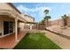 A covered patio, artificial turf, and desert landscaping come together to create a relaxing retreat at 2507 Albemarle Way, Henderson, NV 89014