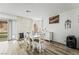 Light-filled dining area with wood floors, a modern fireplace, and a large table for Gathering gatherings at 2507 Albemarle Way, Henderson, NV 89014