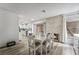 An open-concept dining room is accented by wood floors, a fireplace, and a sliding door at 2507 Albemarle Way, Henderson, NV 89014