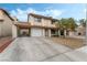 Two-story home boasts a long driveway, two-car garage, and convenient carport at 2507 Albemarle Way, Henderson, NV 89014