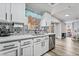 Bright kitchen with stainless steel appliances, white cabinets, and decorative backsplash at 2507 Albemarle Way, Henderson, NV 89014