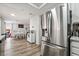 Open kitchen layout with stainless steel fridge and view into dining area at 2507 Albemarle Way, Henderson, NV 89014