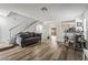 Spacious living room with wood floors, couch, stairs, and bar creates an inviting space at 2507 Albemarle Way, Henderson, NV 89014