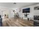 An open-concept living room with wood floors and a built-in bar area is an entertainer's dream at 2507 Albemarle Way, Henderson, NV 89014